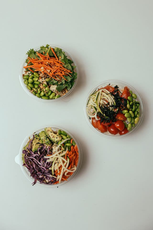 Three bowls of rice and vegetables seen from above