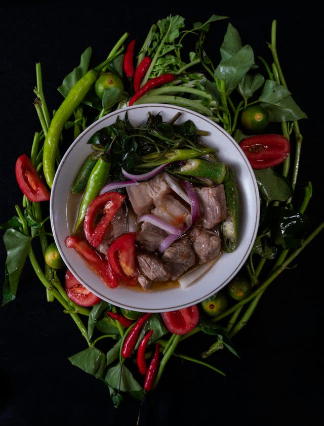 A bowl of sinigang with vegetables
