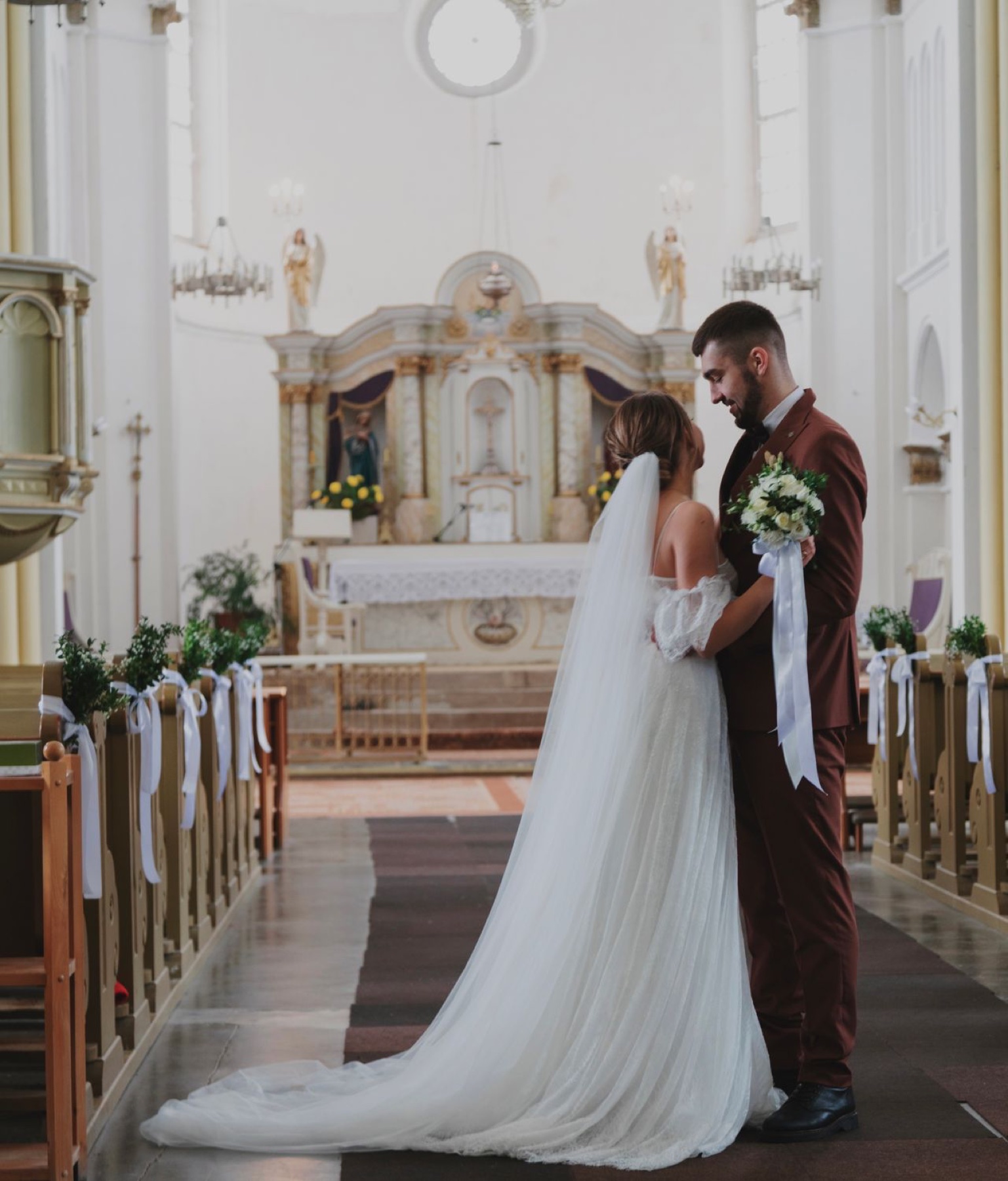 Bride and groom standing together inside a church