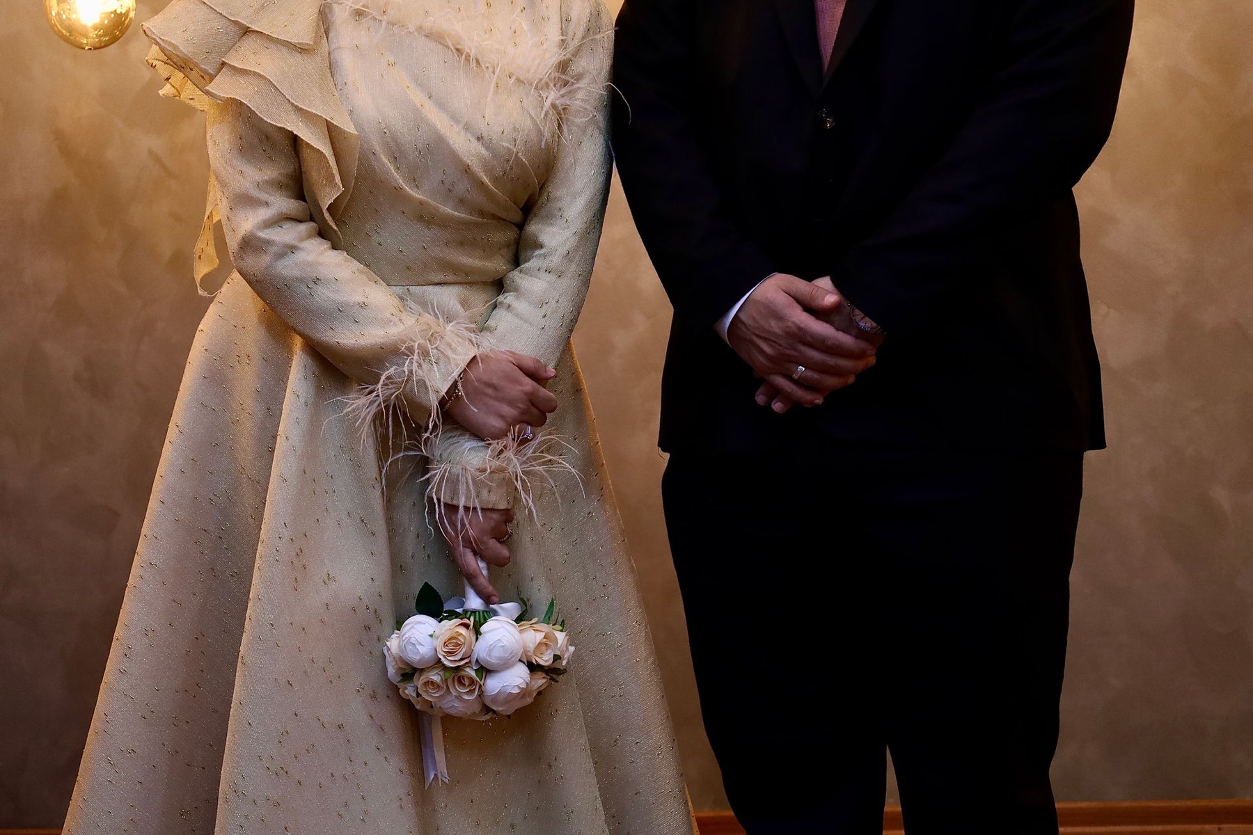 Bride and groom standing together with a bouquet