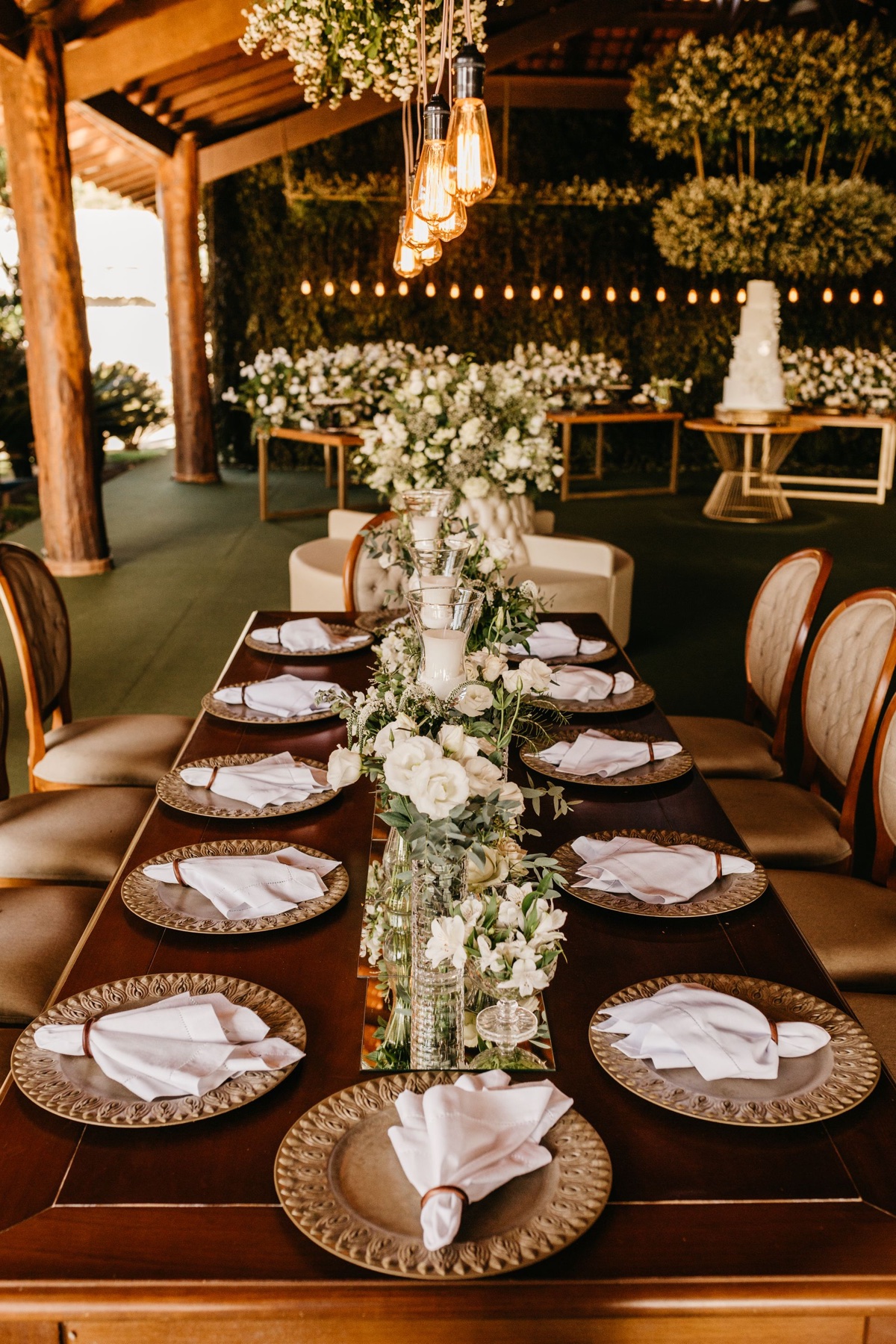 Warmly lit wedding reception table with flowers