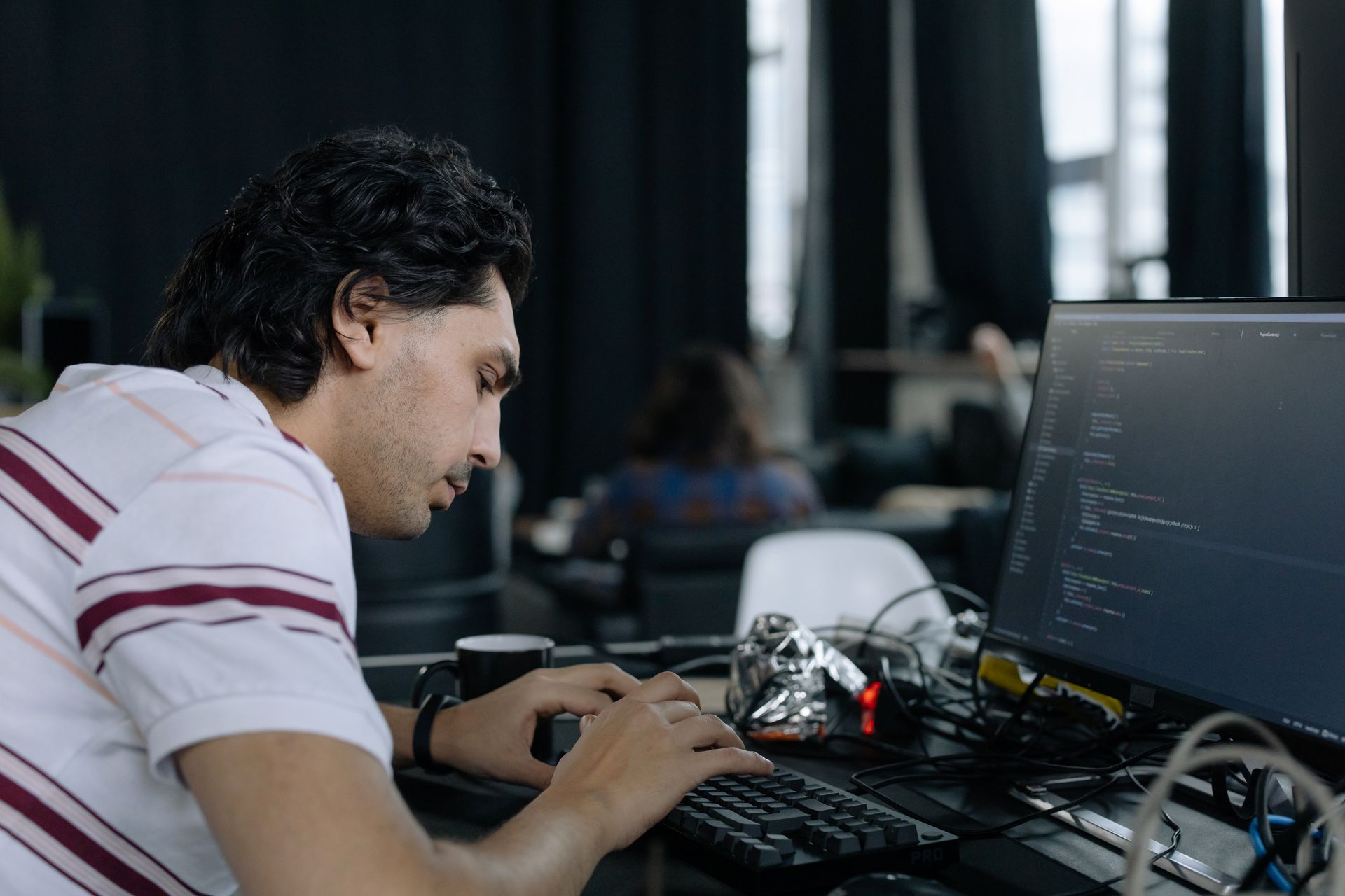 A product engineer focused on building software at a workstation