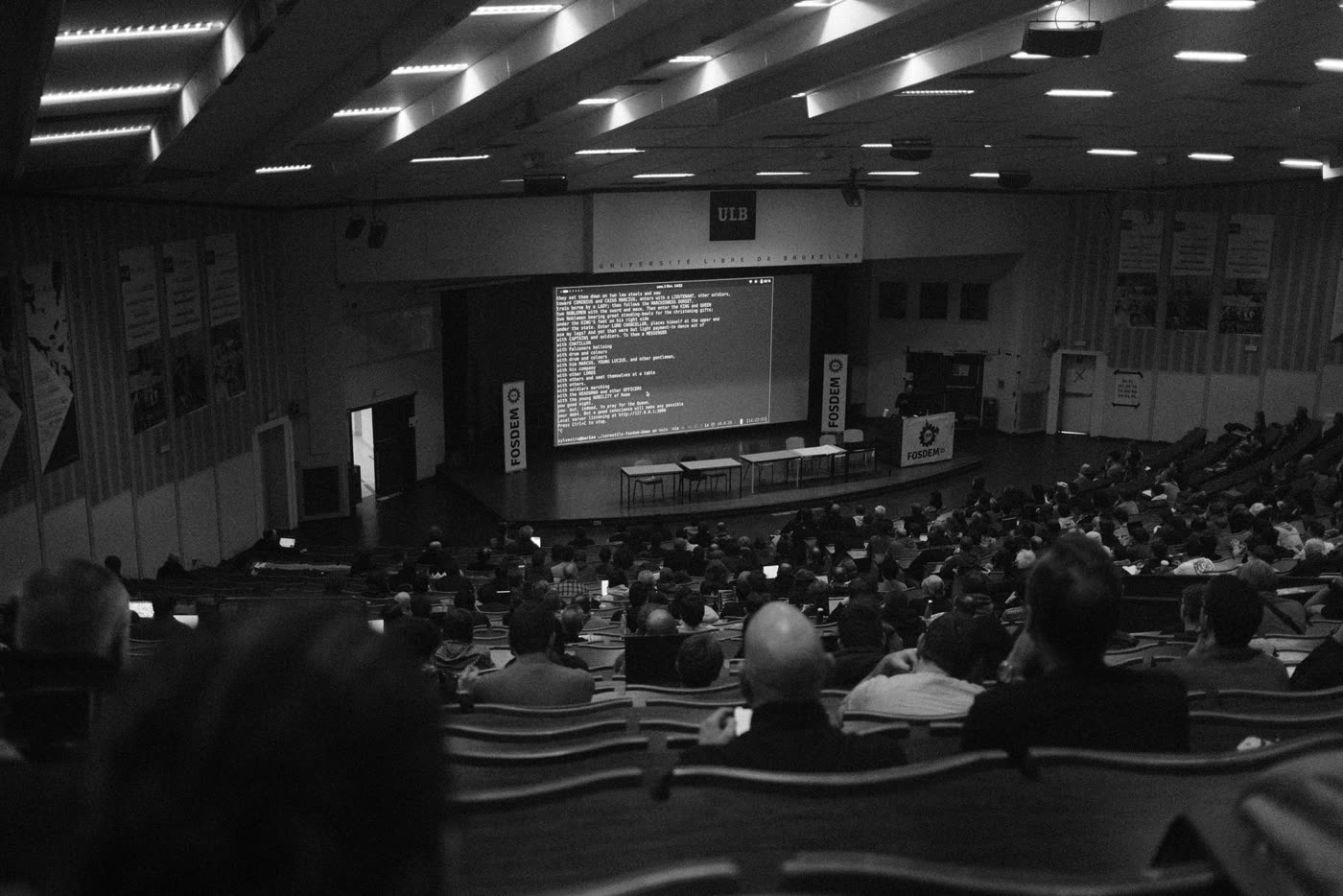 A lecture hall with code projected on the big screen