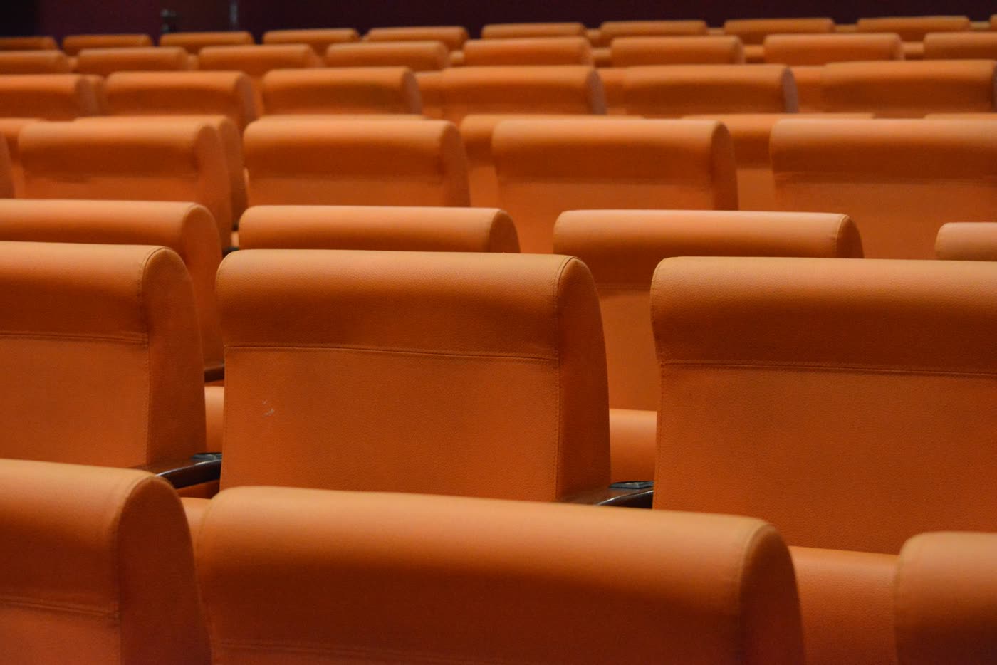 Rows of empty orange theatre seats