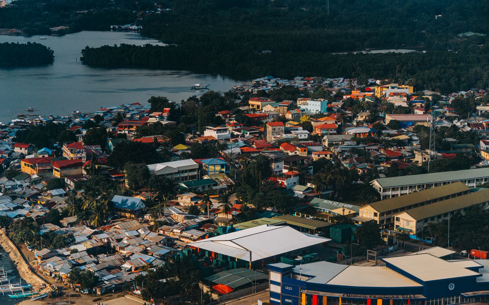 Aerial view of the city's rooftops and streets running down to the bay