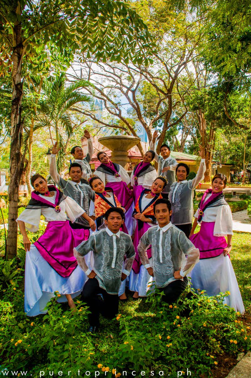 Dancers in Filipiniana and barong posing in a park