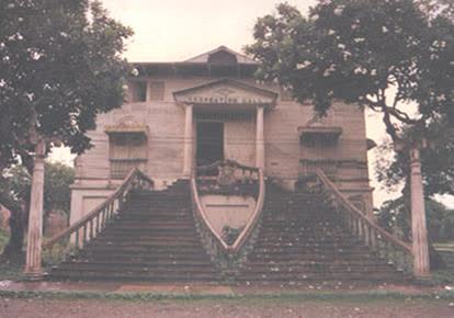 An old wooden building with a wide staircase at Iwahig