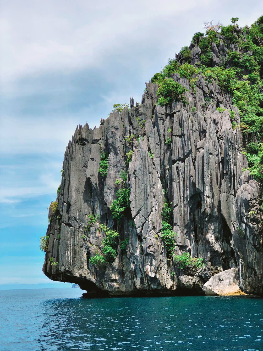 A tall limestone pillar rising from the sea