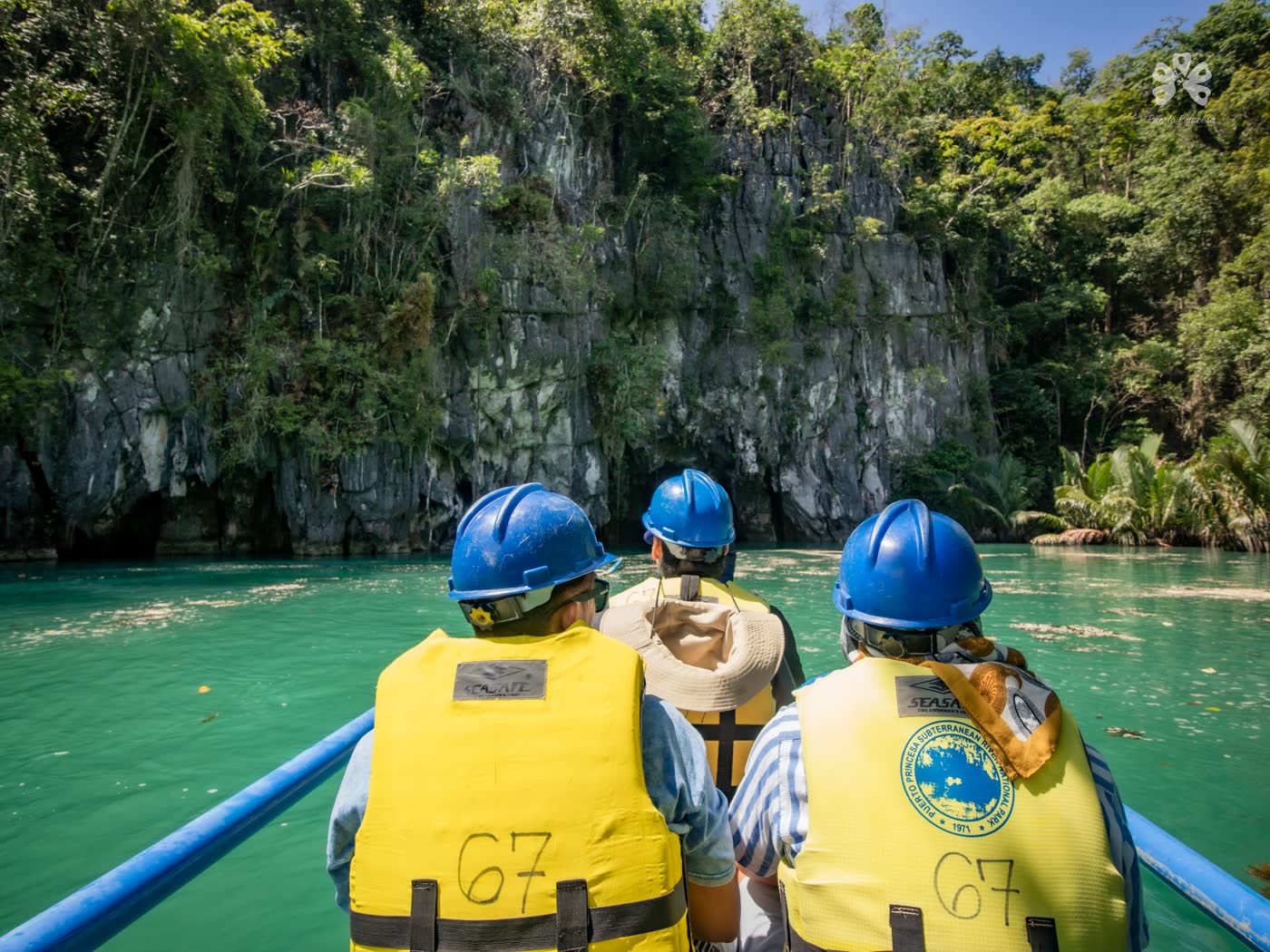 Visitors in blue helmets and life vests paddled toward the cave