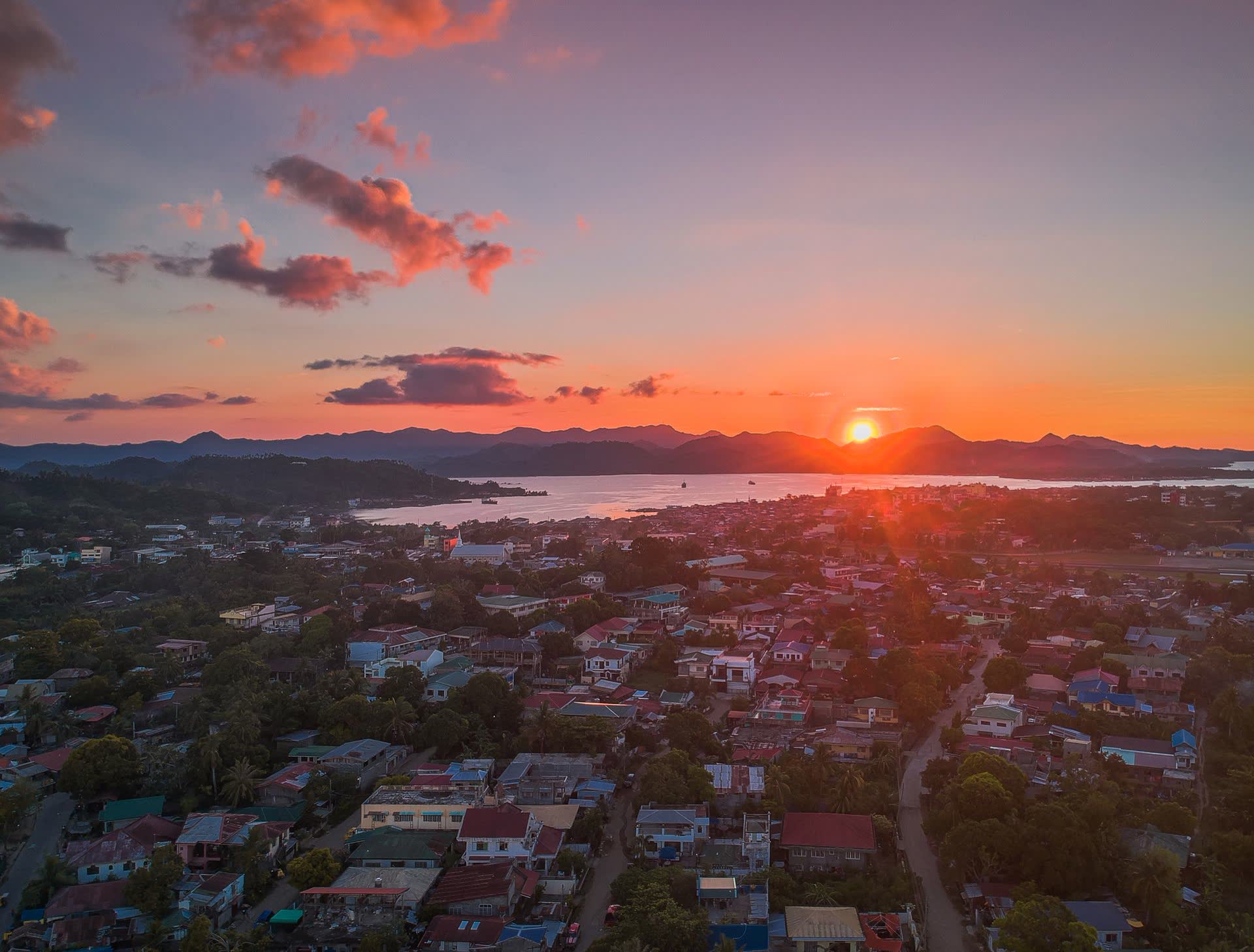 The sun setting over the city and the bay, hills in silhouette