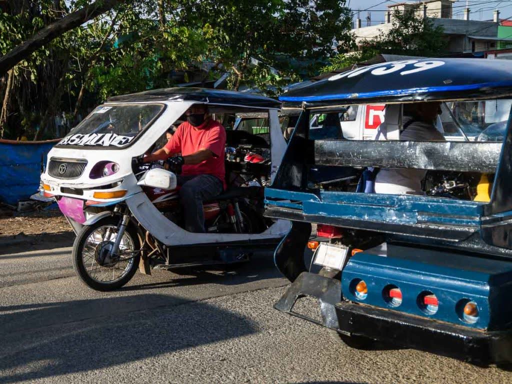 Colourful tricycles waiting at the roadside