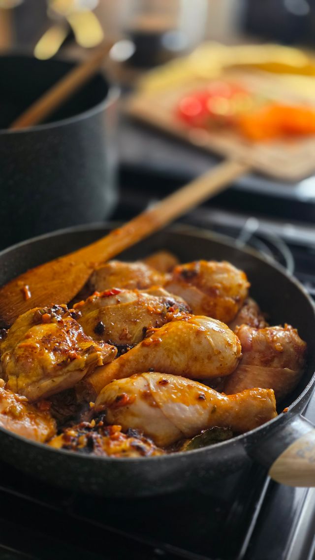 Chicken adobo simmering in a pan