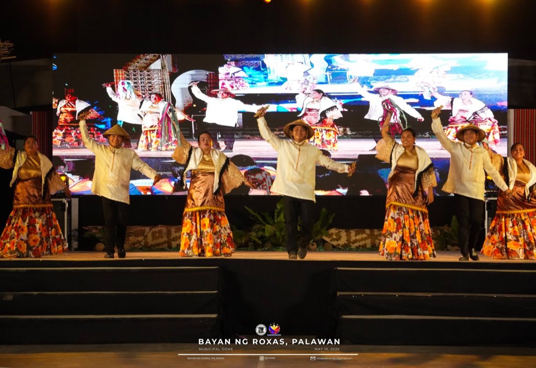 Dancers in barong and patadyong with salakot hats performing a cultural dance on stage