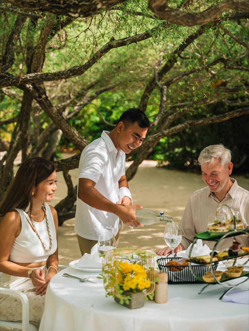 Guests dining by the beach