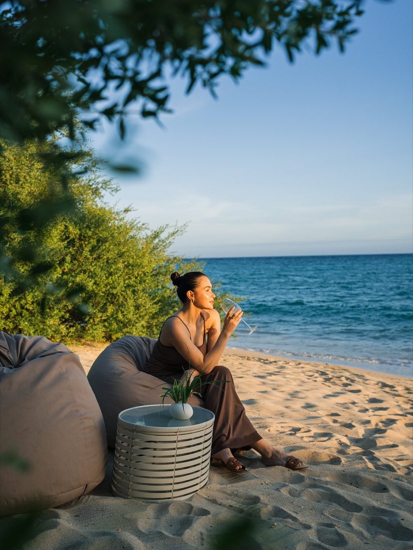 A guest resting by the sea under the palms