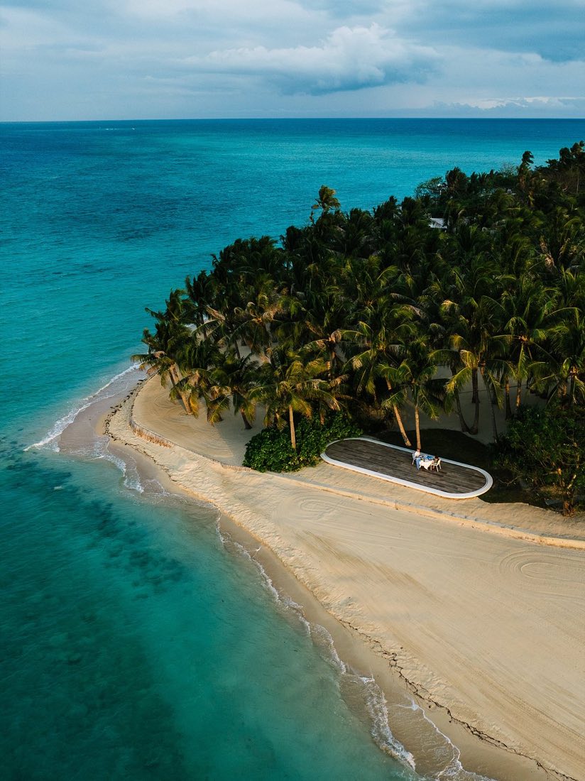 Palms and a white beach along the shore of Banwa