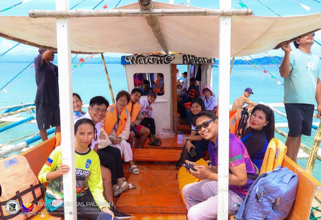 Visitors smiling aboard an island-hopping bangka
