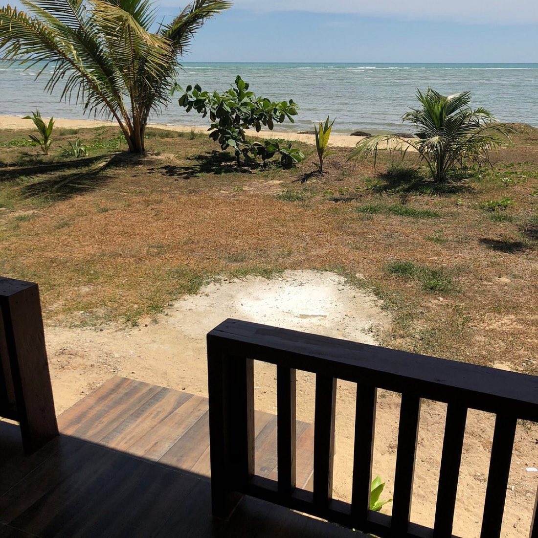 A wooden deck looking out over the beach
