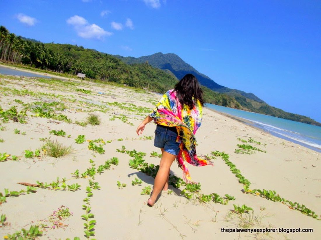 A visitor on the shore with mountains behind