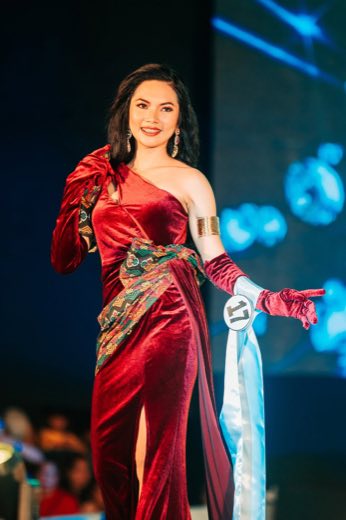 A performer in a red gown on stage