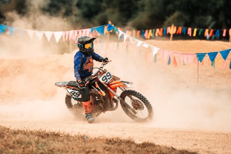 A motocross rider on a sand track