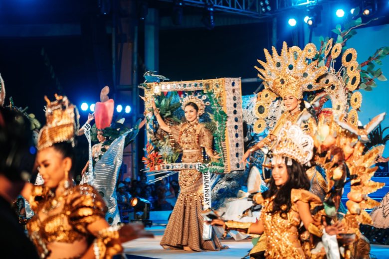 Pageant candidates in costume on stage