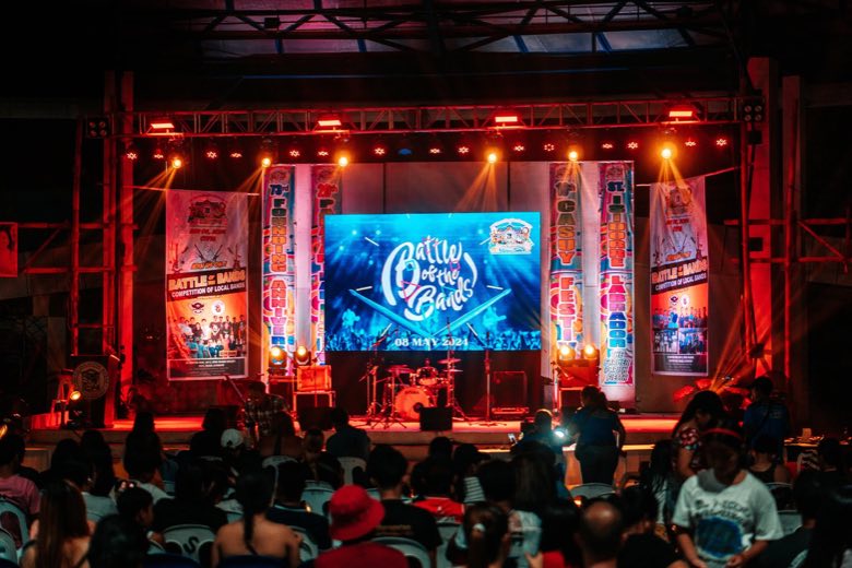 A concert stage in front of a crowd at night