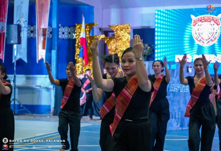 Dancers in red sashes