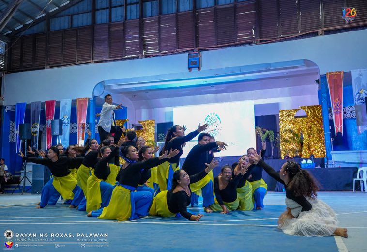A dance group in yellow performing