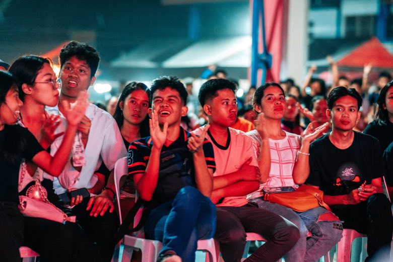 A crowd cheering at a night concert