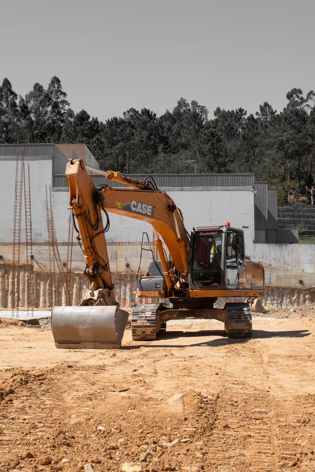 Excavator grading the Riverside site