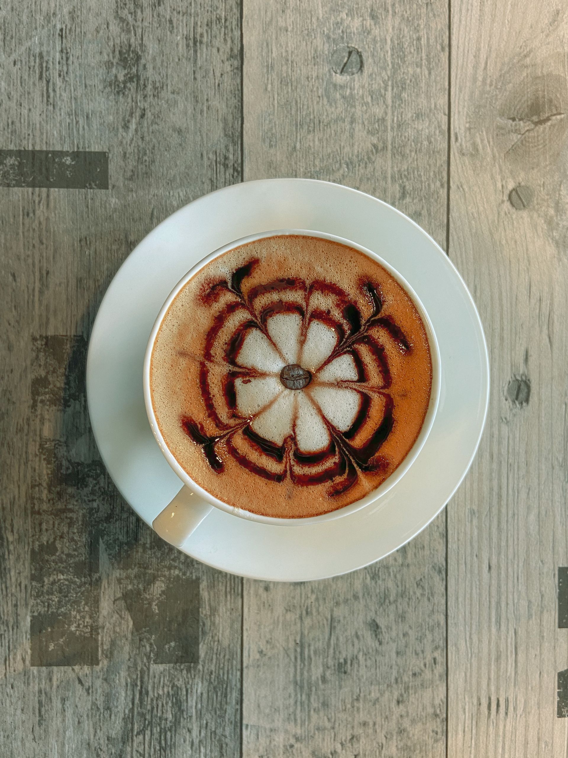 Latte art viewed from above on a dark table