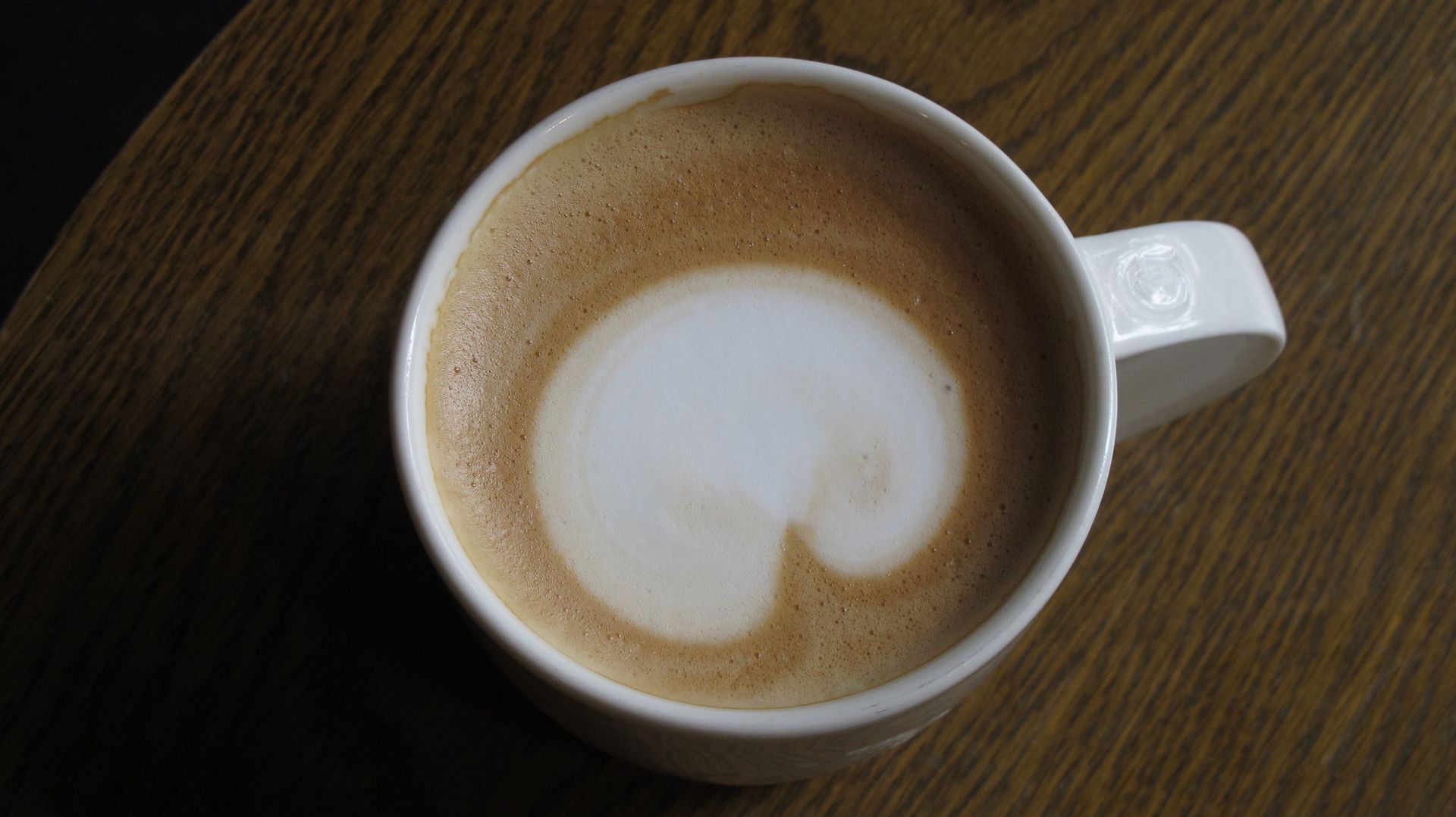 A cappuccino viewed from above on a simple table